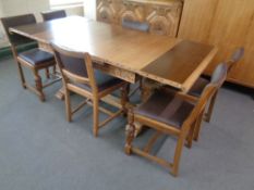 A 1930's eight piece Lees style dining room suite comprising of heavily carved triple door buffet