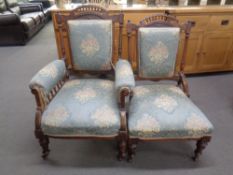 A Victorian mahogany lady's and gent's chair upholstered in a floral brocade fabric