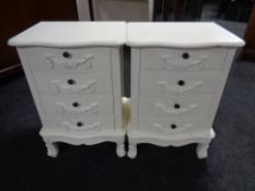 A pair of contemporary cream bedside chests fitted four drawers
