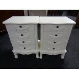 A pair of contemporary cream bedside chests fitted four drawers