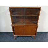 A mid 20th century teak sliding glass door cabinet