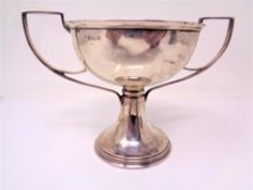 A silver twin handled trophy cup,