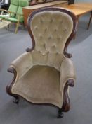 A Victorian mahogany spoon back armchair upholstered in a buttoned dralon