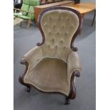 A Victorian mahogany spoon back armchair upholstered in a buttoned dralon