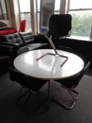 A mid 20th century Dux circular dining table on metal legs together with a set of five tubular