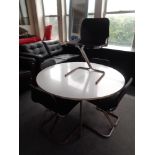 A mid 20th century Dux circular dining table on metal legs together with a set of five tubular