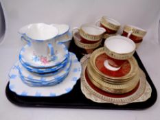 A tray containing two part china tea services by Melba and Grafton