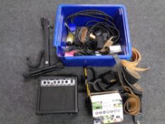 A box containing various music equipment including Deacon guitar amplifier, guitar stand,