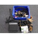 A box containing various music equipment including Deacon guitar amplifier, guitar stand,