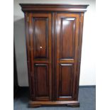 A contemporary mahogany effect two door wardrobe