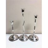 A set of three graduated loaded silver twist candlesticks, stamped 800, tallest 26cm.