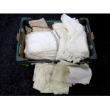 A box containing a quantity of table linen to include a hand made table cloth