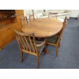 A mid 20th century oval teak G plan extending dining table together with a set of six rail back
