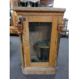 A 19th century continental oak single door cabinet converted to a falconry cabinet and a pair of