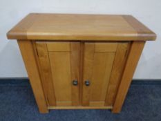 A contemporary oak two door low cabinet,