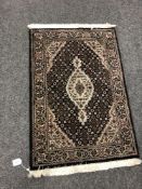 A Tabriz design rug 64 cm x 91 cm