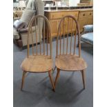 A pair of Ercol solid elm and beech spindle back dining chairs