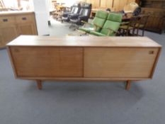 A 20th century Danish sliding door sideboard on raised legs