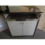 A marble top commercial double door storage cupboard containing cardboard drinks trays,