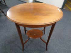 An Edwardian walnut two tier occasional table