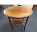 An Edwardian walnut two tier occasional table