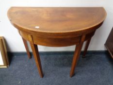 A 19th century inlaid mahogany demi-lune turnover top card table