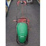 A Qualcast electric lawn mower with grass box and lead