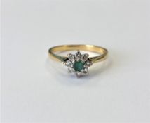 An 18ct gold emerald and diamond cluster ring, size O CONDITION REPORT: 2.
