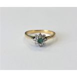 An 18ct gold emerald and diamond cluster ring, size O CONDITION REPORT: 2.