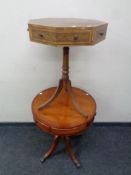 A yew wood pedestal drum table together with a octagonal pedestal table