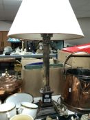 A silver plated Corinthian column table lamp with shade