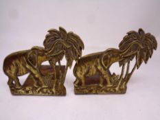 A pair of brass book ends modelled as elephants