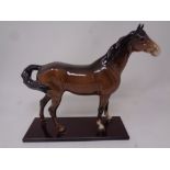 A Beswick brown gloss figure of a horse on stand