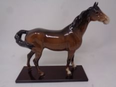 A Beswick brown gloss figure of a horse on stand