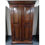 A contemporary mahogany effect two door wardrobe