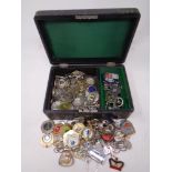 A jewelry box containing a quantity of key rings and medals