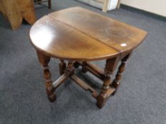 A Titchmarsh & Goodwin small oak drop leaf table retailed by Chapman's