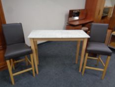 A contemporary marble topped breakfast bar table together with two breakfast bar chairs upholstered