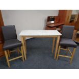 A contemporary marble topped breakfast bar table together with two breakfast bar chairs upholstered