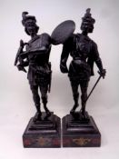 A pair of painted spelter figures on black marble bases