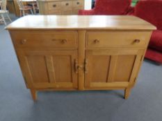 An Ercol elm and beech double door sideboard fitted two drawers