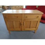 An Ercol elm and beech double door sideboard fitted two drawers