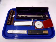 A tray of precision drawing instruments, rulers,
