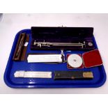 A tray of precision drawing instruments, rulers,