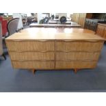 A mid 20th century teak six drawer block chest