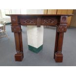 A Victorian style fire surround in a mahogany finish