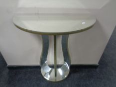 A contemporary mirrored D-shaped side table