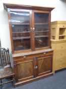 A Victorian mahogany glazed double door bookcase