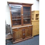 A Victorian mahogany glazed double door bookcase