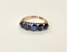 A 9ct gold five stone synthetic sapphire ring, size N CONDITION REPORT: 3.